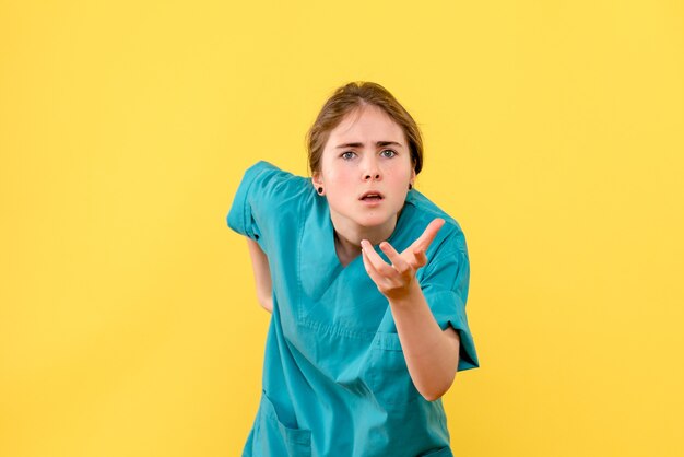 Front view female doctor on yellow background health hospital color virus