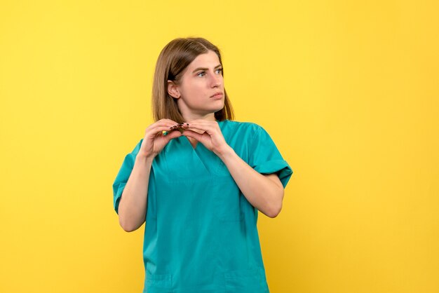 Front view female doctor on a yellow space