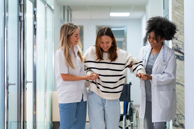 Front view female doctors helping patient