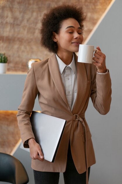 Front view female economist holding laptop