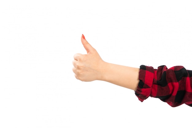 A front view female hand in black-red checkered shirt showing awesome sign on the white