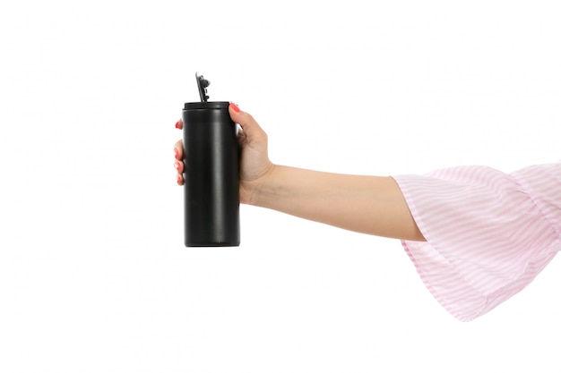 A front view female hand holding black thermos on the white