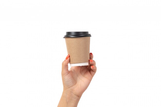 A front view female hand holding cup of coffee on white