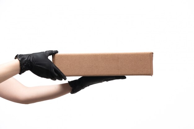 A front view female hand holding food package on white