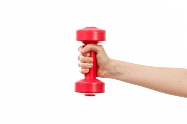 A front view female hand holding red dumbbell on the white