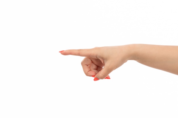 A front view female hand with colored nails pointed finger on the white