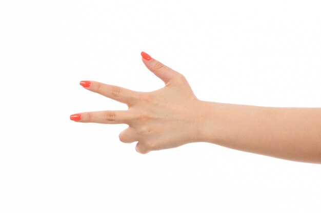 A front view female hand with colored nails pointed fingers on the white