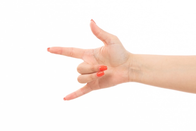 A front view female hand with colored nails rocker sign on the white