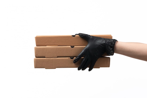 Free photo a front view female hands in black gloves holding delivery boxes on white