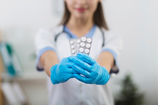 Front view female hands holding pills