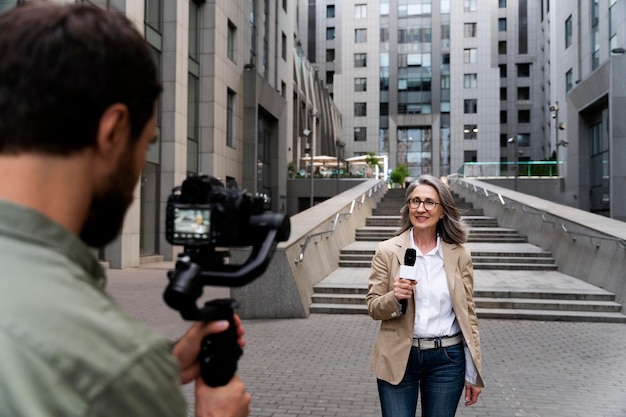 Front view female journalist taking an interview