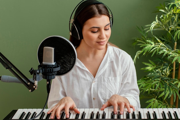 Front view of female musician playing piano keyboard
