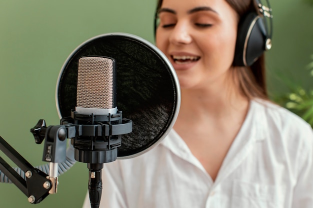 Front view of female musician singing into microphone