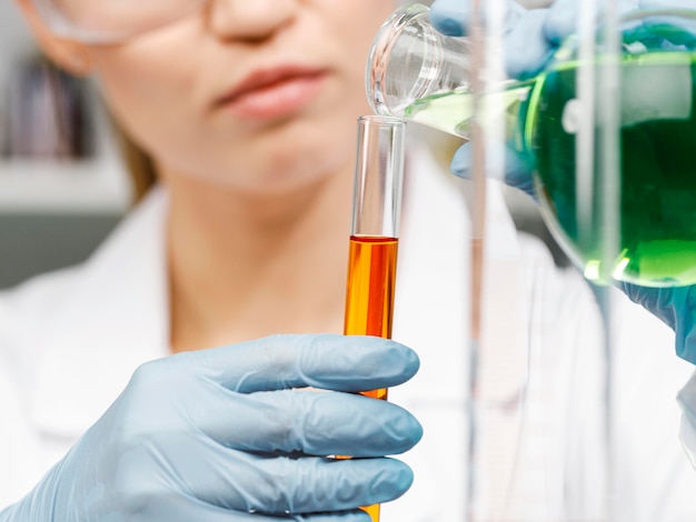 Front view of female researcher with gloves and test tubes