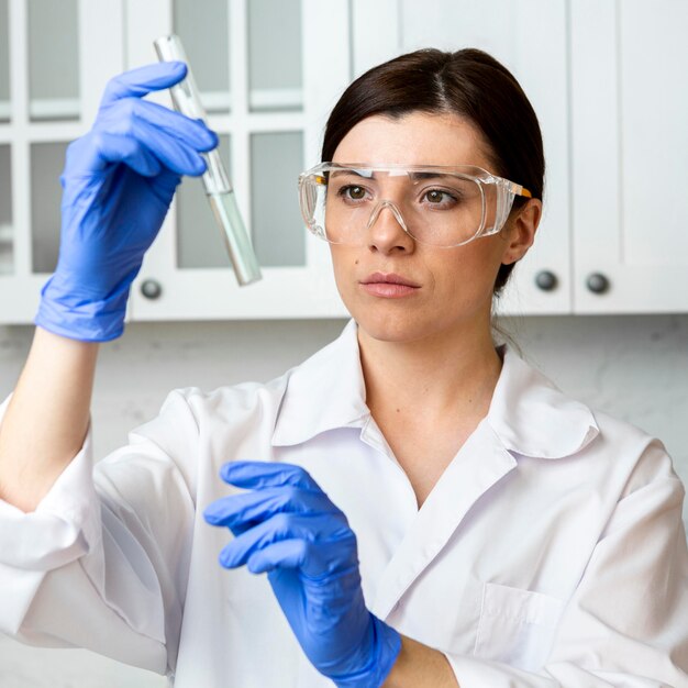 Front view of female researcher with test tube