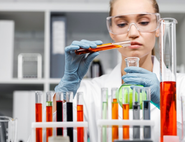 Front view of female researcher with test tubes