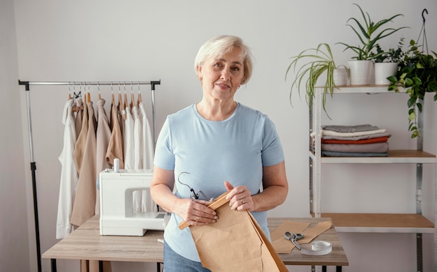 Free photo front view of female seamstress in the studio