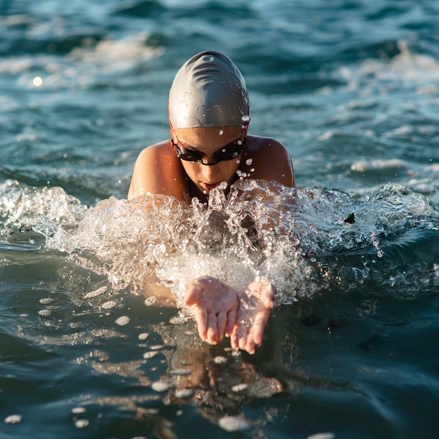 Front view of female swimmer swimming in water