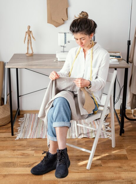 Front view of female tailor working in the studio