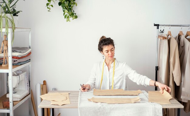 Front view of female tailor working in the studio