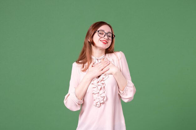 Front view female teacher in pink blouse on green background color work book student library young lesson college school job