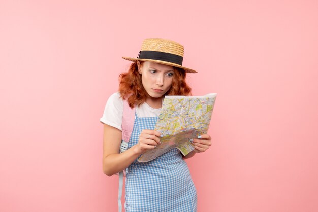 Front view female tourist exploring map trying to find direction in foreign city