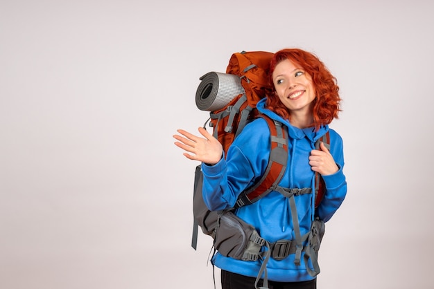 Front view female tourist going in mountain trip with backpack