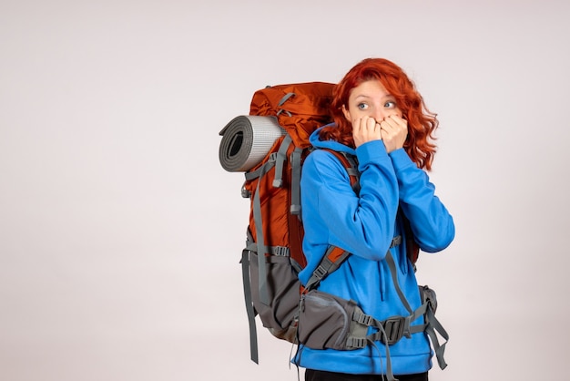 Front view female tourist going in mountain trip with backpack