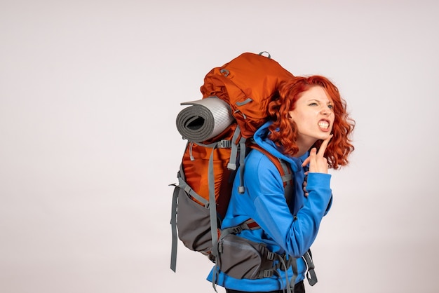 Front view female tourist going in mountain trip with backpack