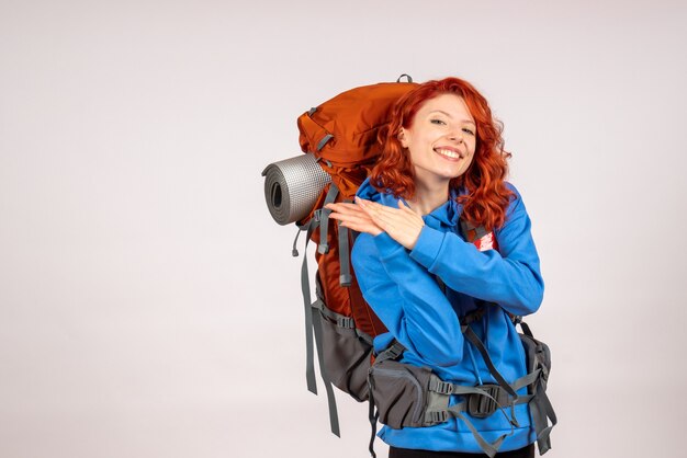 Front view female tourist going in mountain trip with backpack