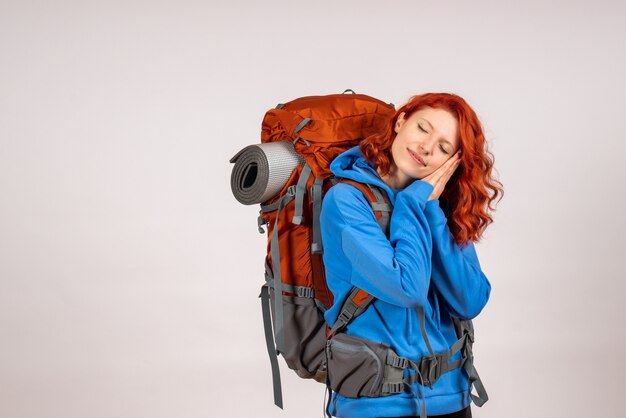 Front view female tourist going in mountain trip with backpack