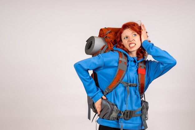 Front view female tourist going in mountain trip with backpack