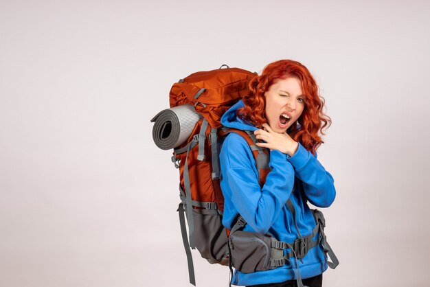 Front view female tourist going in mountain trip with backpack