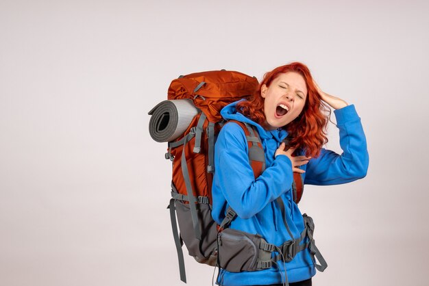 Front view female tourist going in mountain trip with backpack