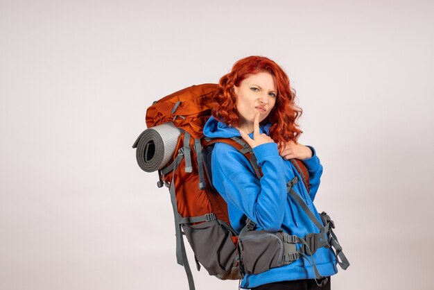 Front view female tourist going in mountain trip with backpack