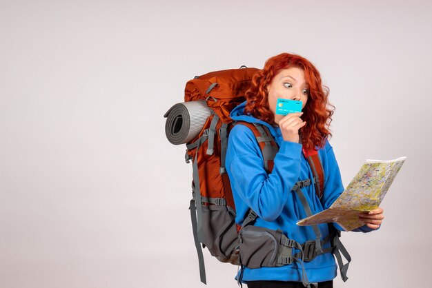 Front view female tourist going in mountain trip with map and bank card