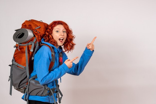 Front view female tourist going in mountain trip