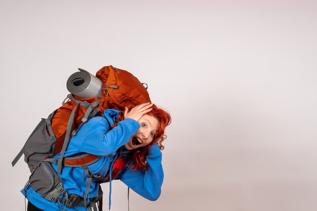 Front view female tourist going in mountain trip