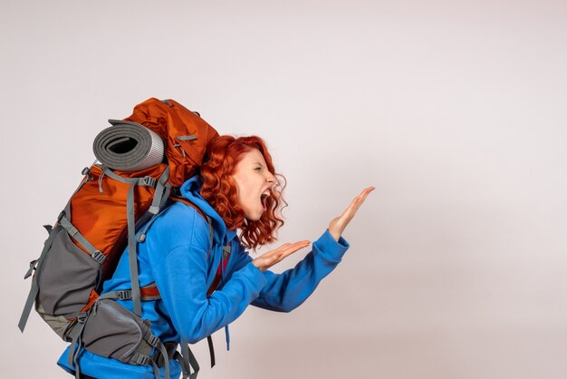 Front view female tourist going in mountain trip