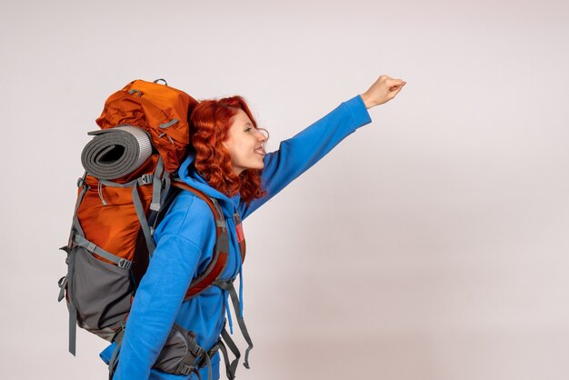 Front view female tourist going in mountain trip