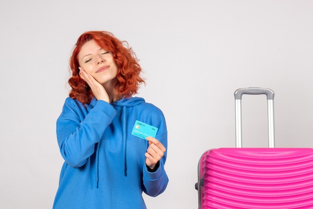 Front view female tourist holding bank card