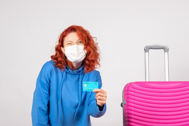 Front view female tourist holding bank card