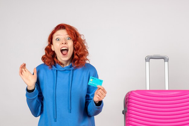 Front view female tourist holding bank card