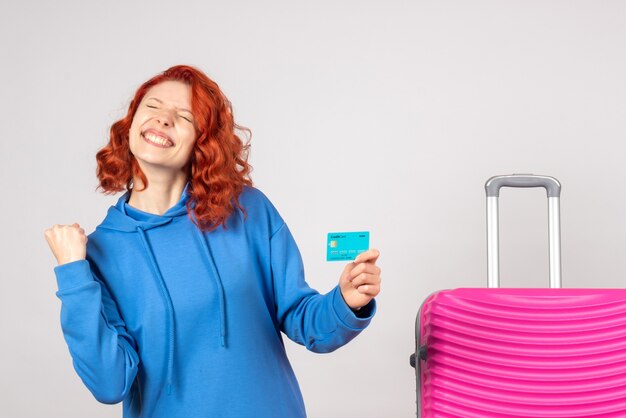 Front view female tourist holding bank card