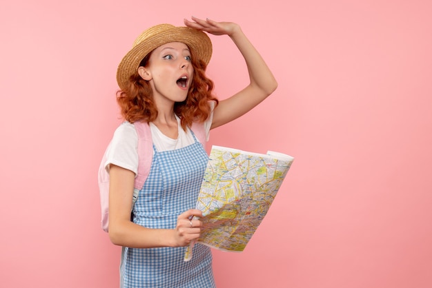 Front view female tourist with map trying to find direction in foreign country