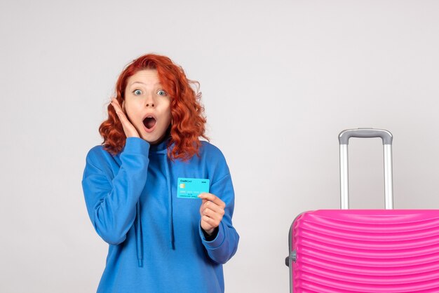 Front view female tourist with pink bag and bank card