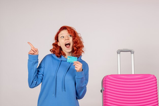 Front view female tourist with pink bag and holding bank card