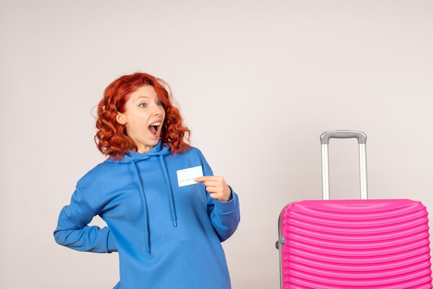 Женщина-туристка с розовой сумкой и банковской картой, вид спереди