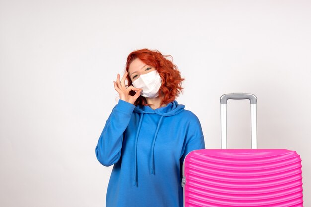 Front view female tourist with pink bag in mask