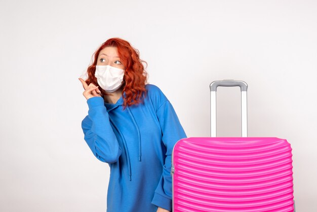 Front view female tourist with pink bag in mask